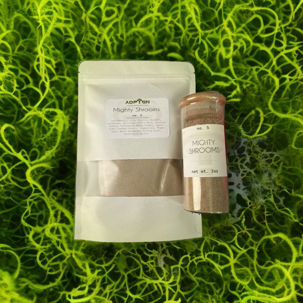 ADPTGN Mighty Shrooms refill pouch and jar on green moss